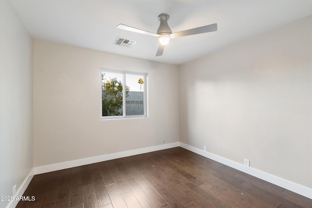 empty room with ceiling fan and dark hardwood / wood-style flooring