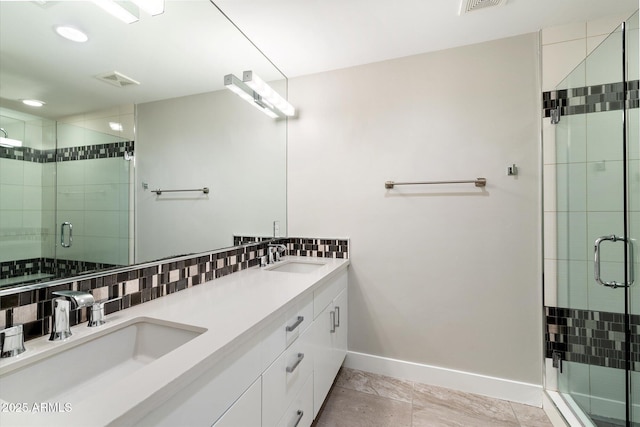 bathroom with backsplash, walk in shower, and vanity