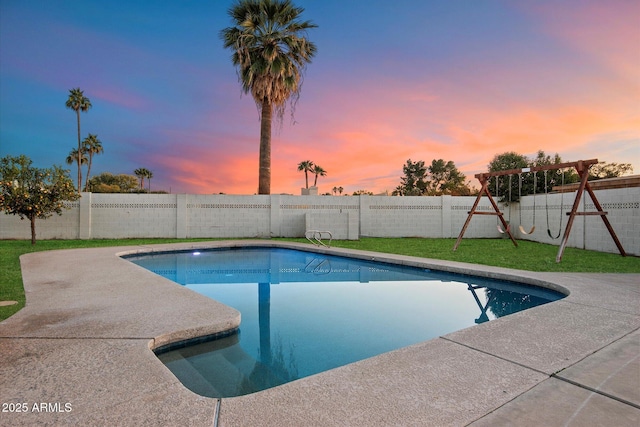 pool at dusk with a playground