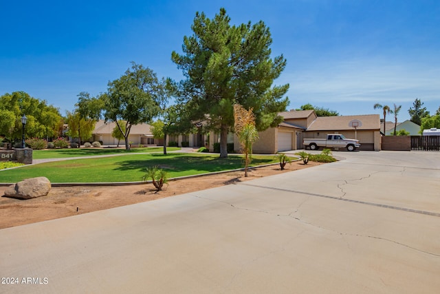 view of front of property featuring a garage and a front lawn