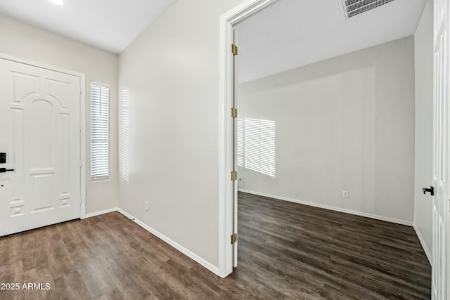 entryway with baseboards, visible vents, and dark wood finished floors