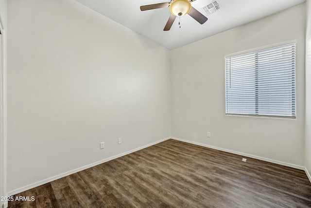 unfurnished room with a ceiling fan, dark wood-style flooring, visible vents, and baseboards