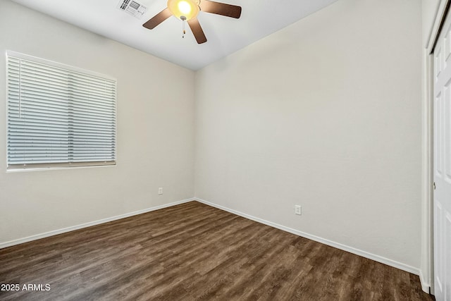 unfurnished bedroom featuring dark wood-style floors, visible vents, and baseboards