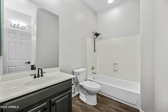 bathroom with vanity, shower / washtub combination, wood finished floors, and toilet