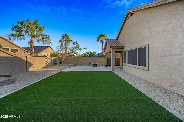 view of yard with a patio area and a fenced backyard