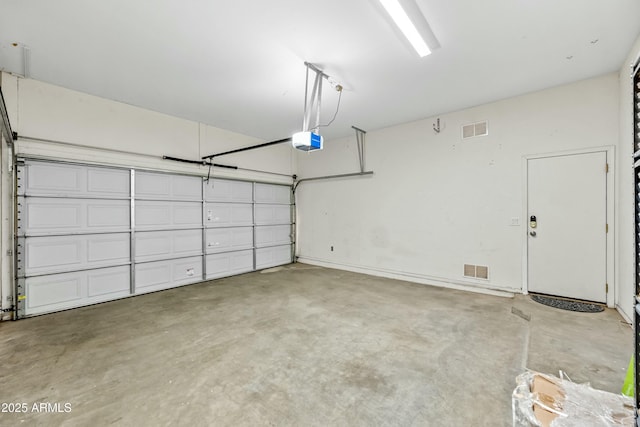 garage with visible vents and a garage door opener