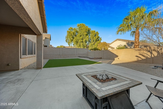 view of patio / terrace with a fire pit and a fenced backyard