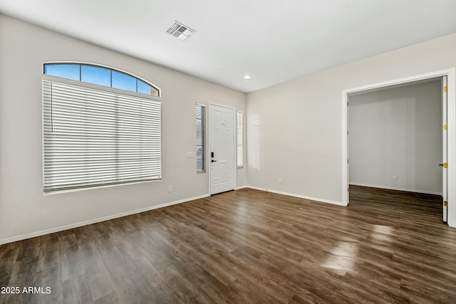 entryway featuring dark wood-type flooring, recessed lighting, visible vents, and baseboards