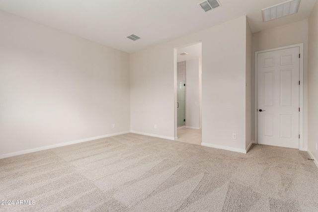 unfurnished room with light carpet