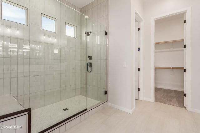 bathroom with a shower with door