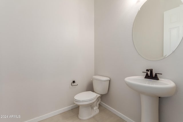 bathroom with sink, tile patterned flooring, and toilet