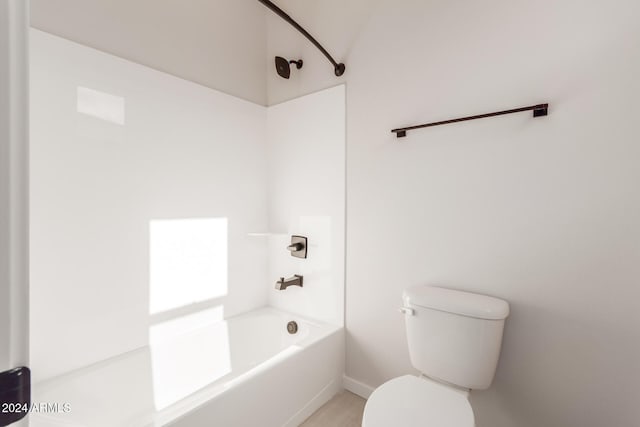 bathroom with toilet and washtub / shower combination