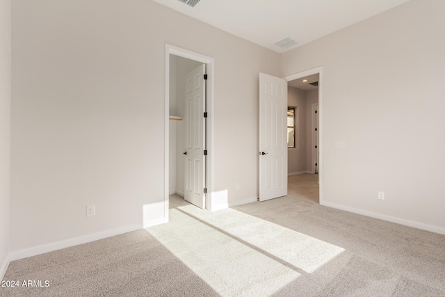 unfurnished bedroom featuring light colored carpet