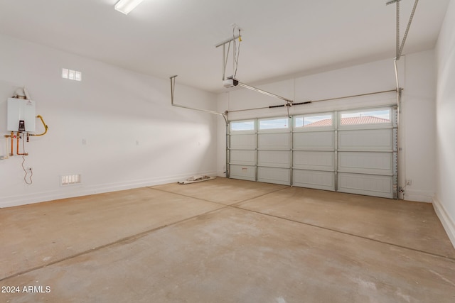 garage featuring a garage door opener and water heater