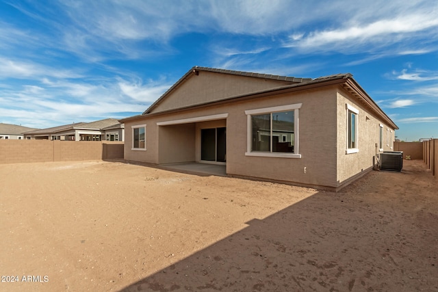 rear view of property with central AC and a patio