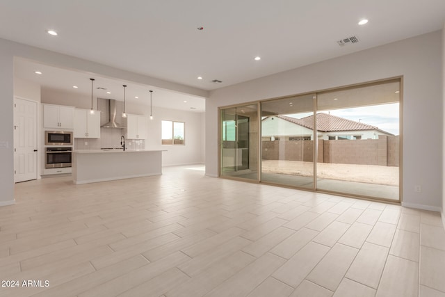 unfurnished living room with sink