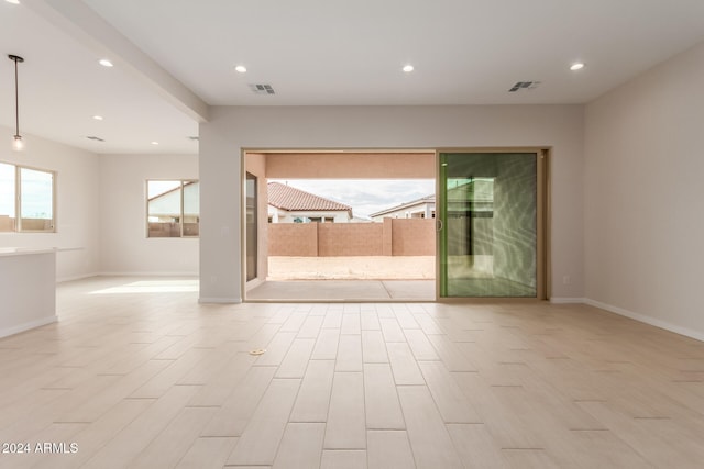 unfurnished room featuring a wealth of natural light