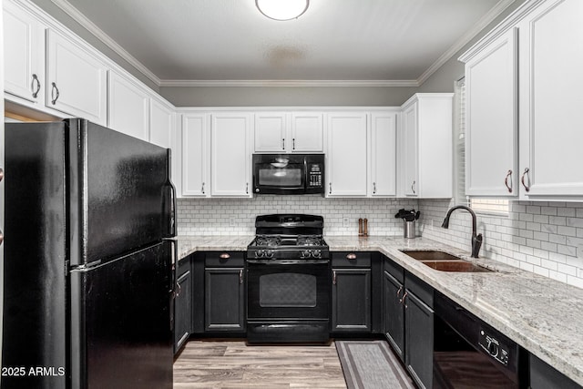 29606 N Tatum Blvd Unit 245, Cave Creek, AZ 85331 - kitchen featuring black appliances, a sink, white cabinetry, ornamental molding, and light stone countertops