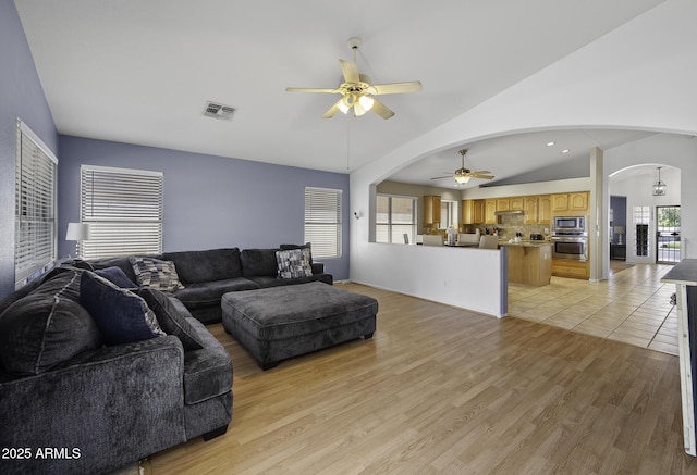 7832 E Osage Ave, Mesa, AZ 85212 - living area featuring light wood finished floors, ceiling fan, visible vents, and arched walkways