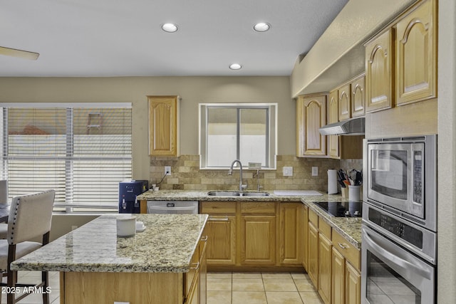 7832 E Osage Ave, Mesa, AZ 85212 - kitchen with light stone counters, tasteful backsplash, a sink, stainless steel appliances, and under cabinet range hood