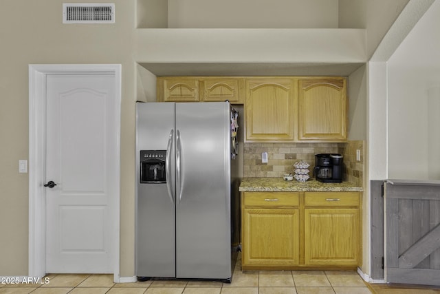 7832 E Osage Ave, Mesa, AZ 85212 - kitchen featuring light stone countertops, light tile patterned floors, backsplash, visible vents, and stainless steel refrigerator with ice dispenser