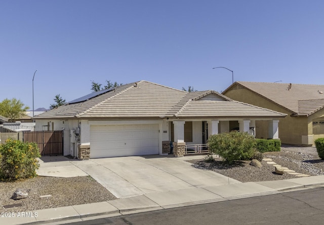 7832 E Osage Ave, Mesa, AZ 85212 - ranch-style house featuring driveway, stone siding, a gate, a porch, and a garage