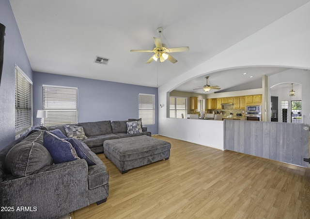 7832 E Osage Ave, Mesa, AZ 85212 - living area featuring light wood finished floors, ceiling fan, visible vents, arched walkways, and lofted ceiling