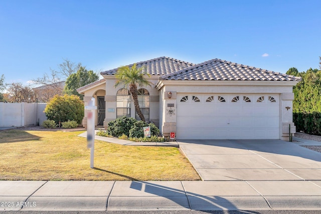 mediterranean / spanish-style home with a garage and a front yard