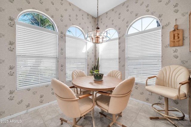 tiled dining space featuring a chandelier