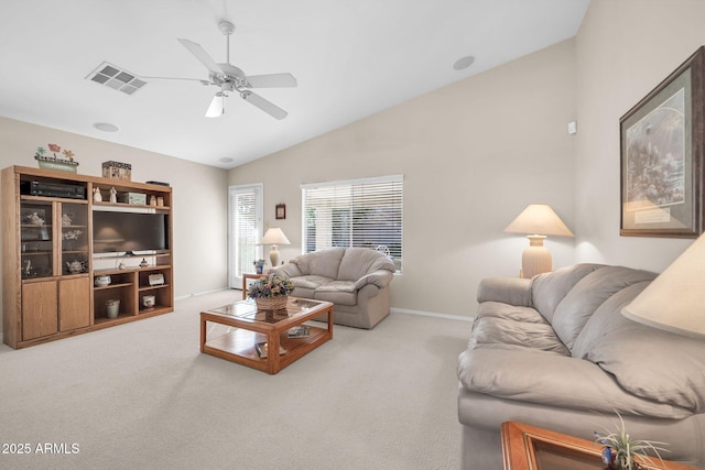 carpeted living room with ceiling fan and lofted ceiling