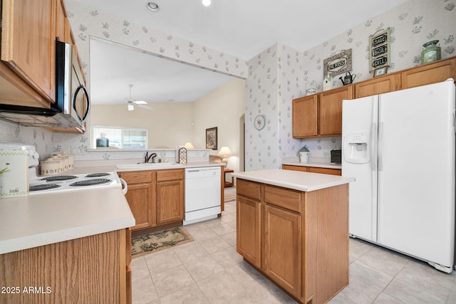 kitchen featuring sink, white appliances, light tile patterned floors, a kitchen island, and ceiling fan