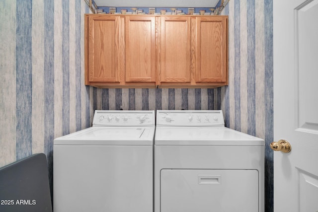 washroom with cabinets and washing machine and clothes dryer