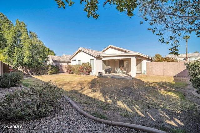 back of house featuring a yard and a patio area