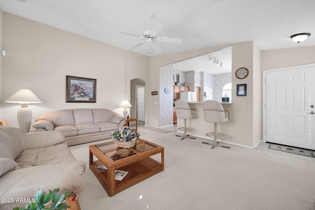 carpeted living room featuring ceiling fan