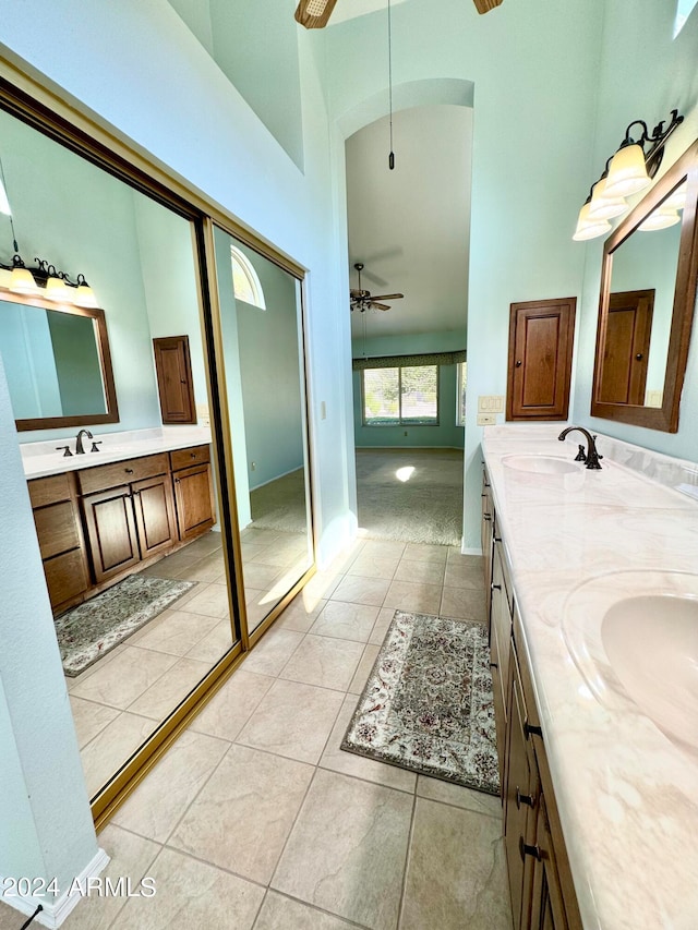 bathroom featuring a high ceiling, tile patterned flooring, ceiling fan, and vanity