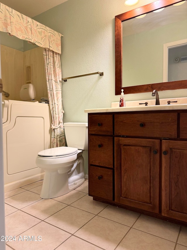 bathroom with vanity, toilet, and tile patterned floors