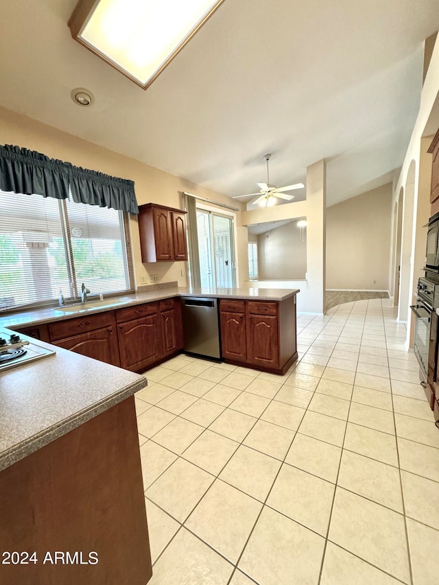 kitchen with light tile patterned flooring, white gas cooktop, kitchen peninsula, ceiling fan, and stainless steel dishwasher