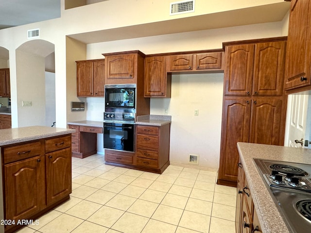 kitchen featuring black appliances and light tile patterned floors