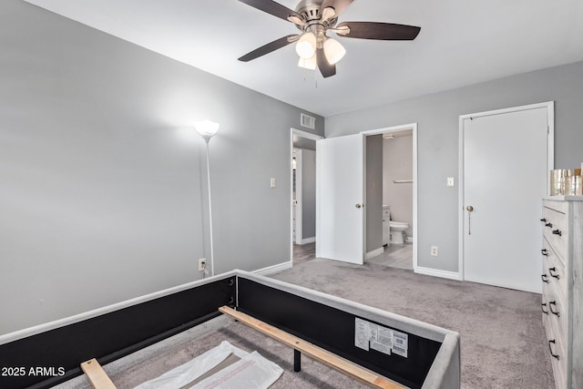 carpeted bedroom with ceiling fan and ensuite bath