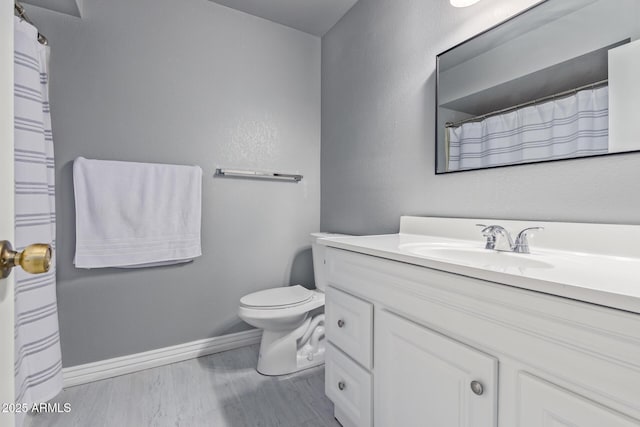 bathroom with vanity, hardwood / wood-style flooring, and toilet