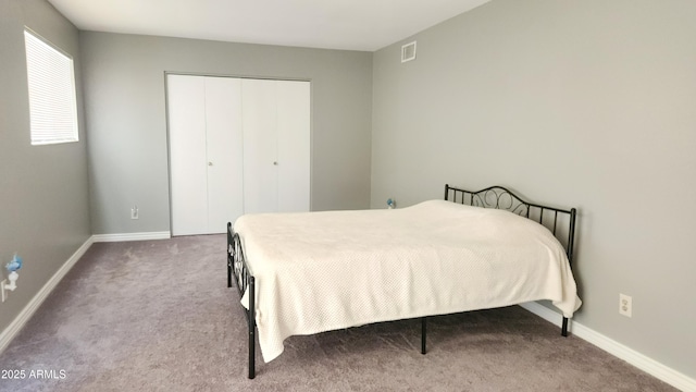 bedroom with light carpet and a closet