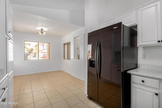 kitchen with white cabinetry, light tile patterned floors, and black refrigerator with ice dispenser