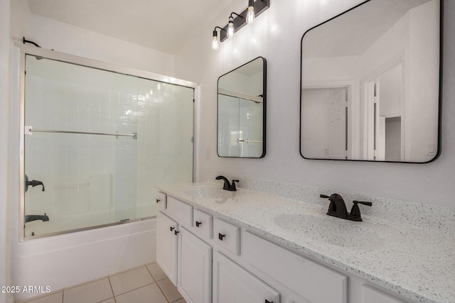 bathroom with tile patterned flooring, vanity, and enclosed tub / shower combo