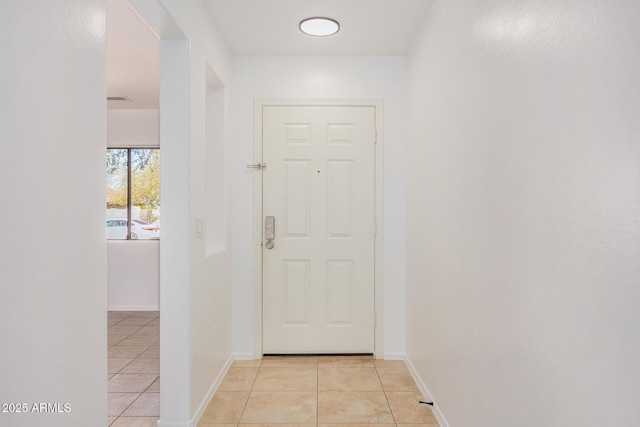 doorway with light tile patterned floors