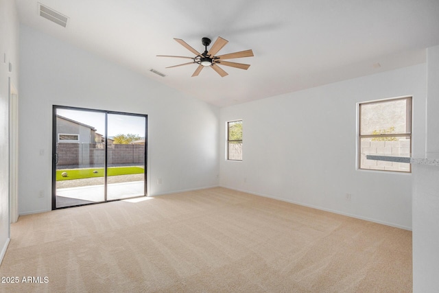 carpeted spare room with lofted ceiling and ceiling fan