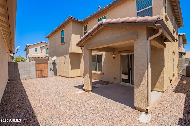 5113 E Greenway St E, Mesa, AZ 85205 - back of house featuring stucco siding, a gate, a patio area, and a tile roof