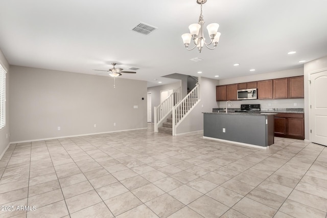 5113 E Greenway St E, Mesa, AZ 85205 - kitchen with stainless steel microwave, range with electric stovetop, ceiling fan, recessed lighting, and open floor plan