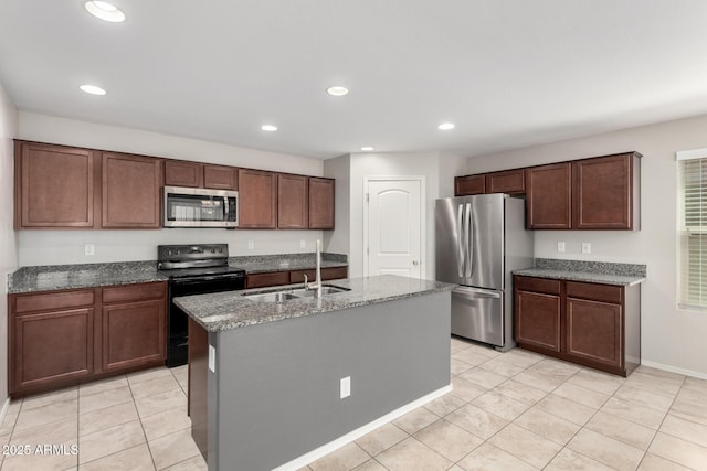 5113 E Greenway St E, Mesa, AZ 85205 - kitchen featuring appliances with stainless steel finishes, light tile patterned floors, stone counters, recessed lighting, and a kitchen island with sink