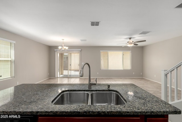 5113 E Greenway St E, Mesa, AZ 85205 - kitchen with open floor plan, dark stone countertops, a chandelier, ceiling fan, and an island with sink