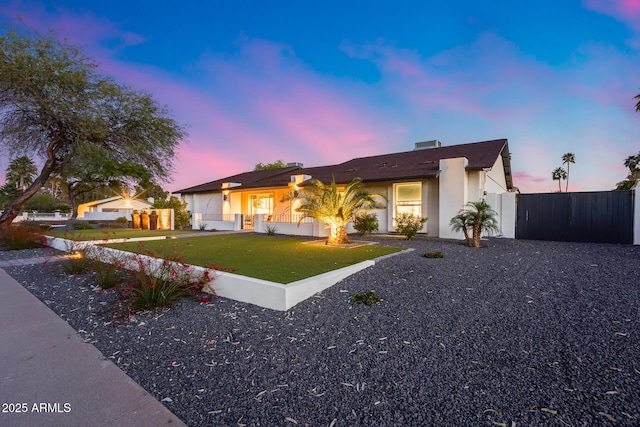 single story home with fence, an attached garage, a lawn, and stucco siding